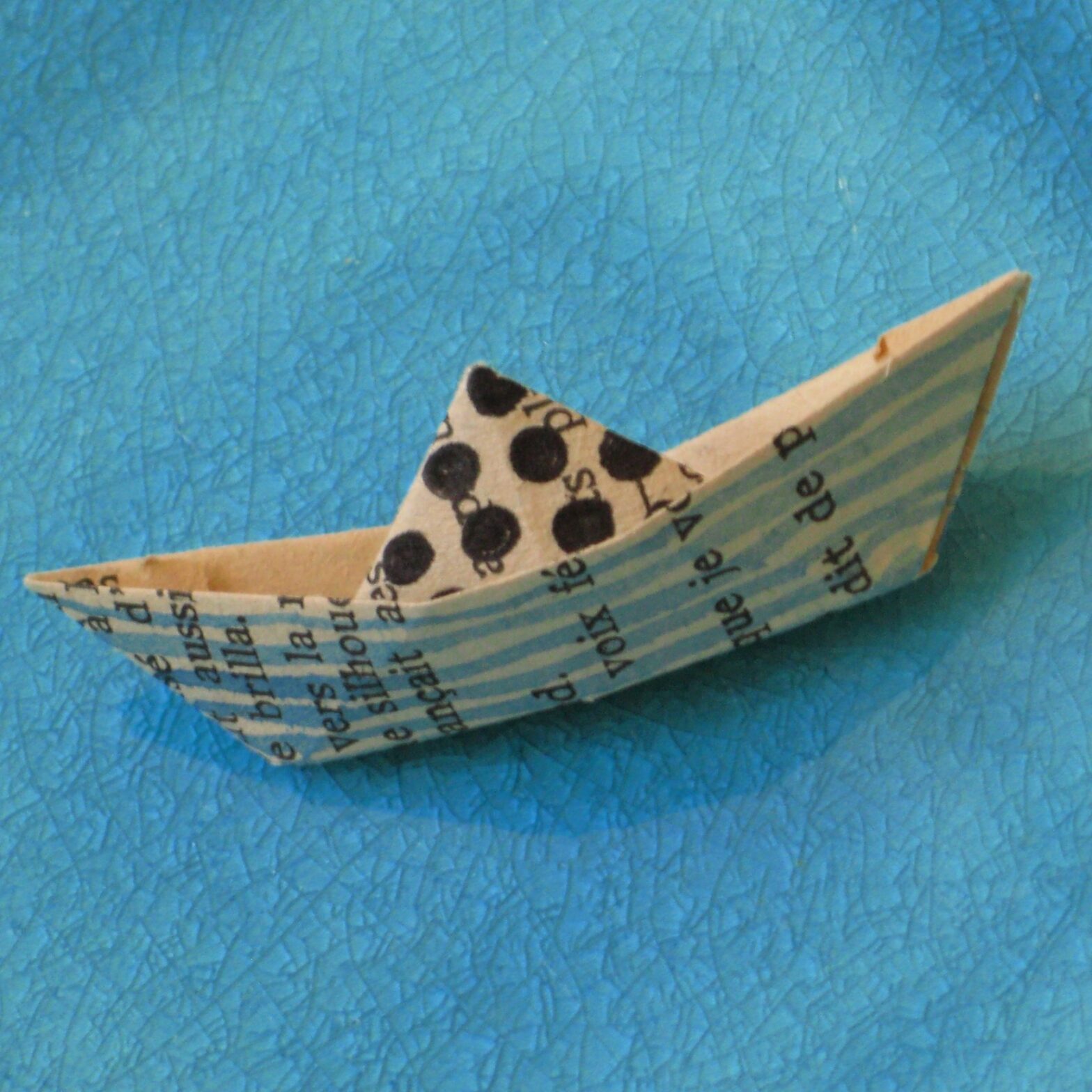 Origami boats made out of old books - art by Tine Steiss