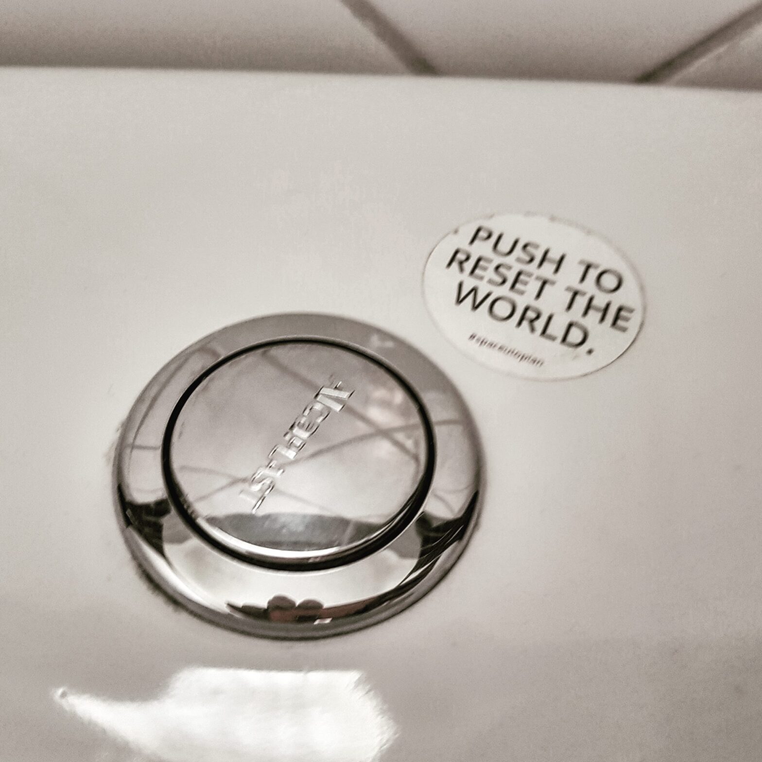 there's no workaround for accountability - toilet flush button with sticker saying "push to reset the world"