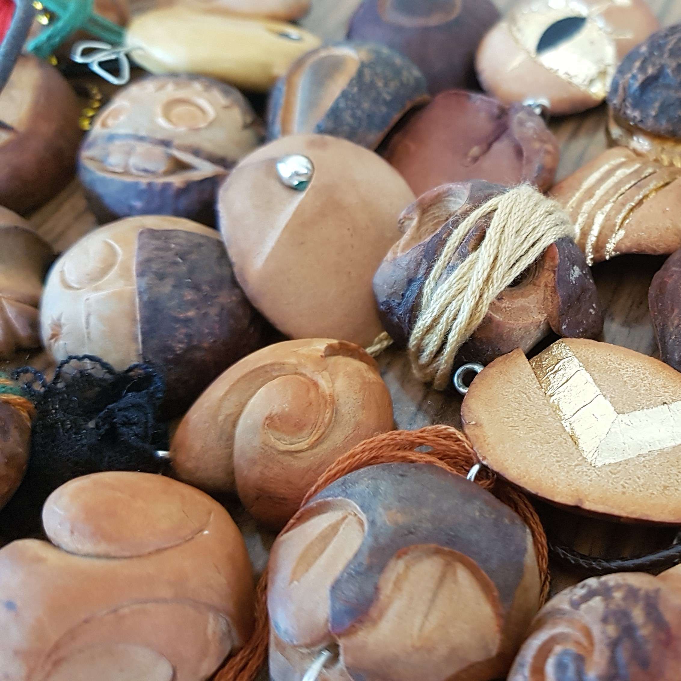 Fuck eco minimalism - the picture shown many of the avocado seed pendants on a pile