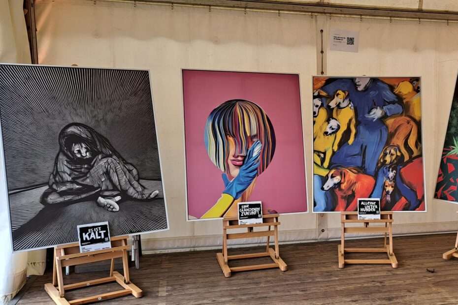 Photo from our visit at the https://homeless-gallery.com/ three big prints on canvas displayed on isles in a tent a visible