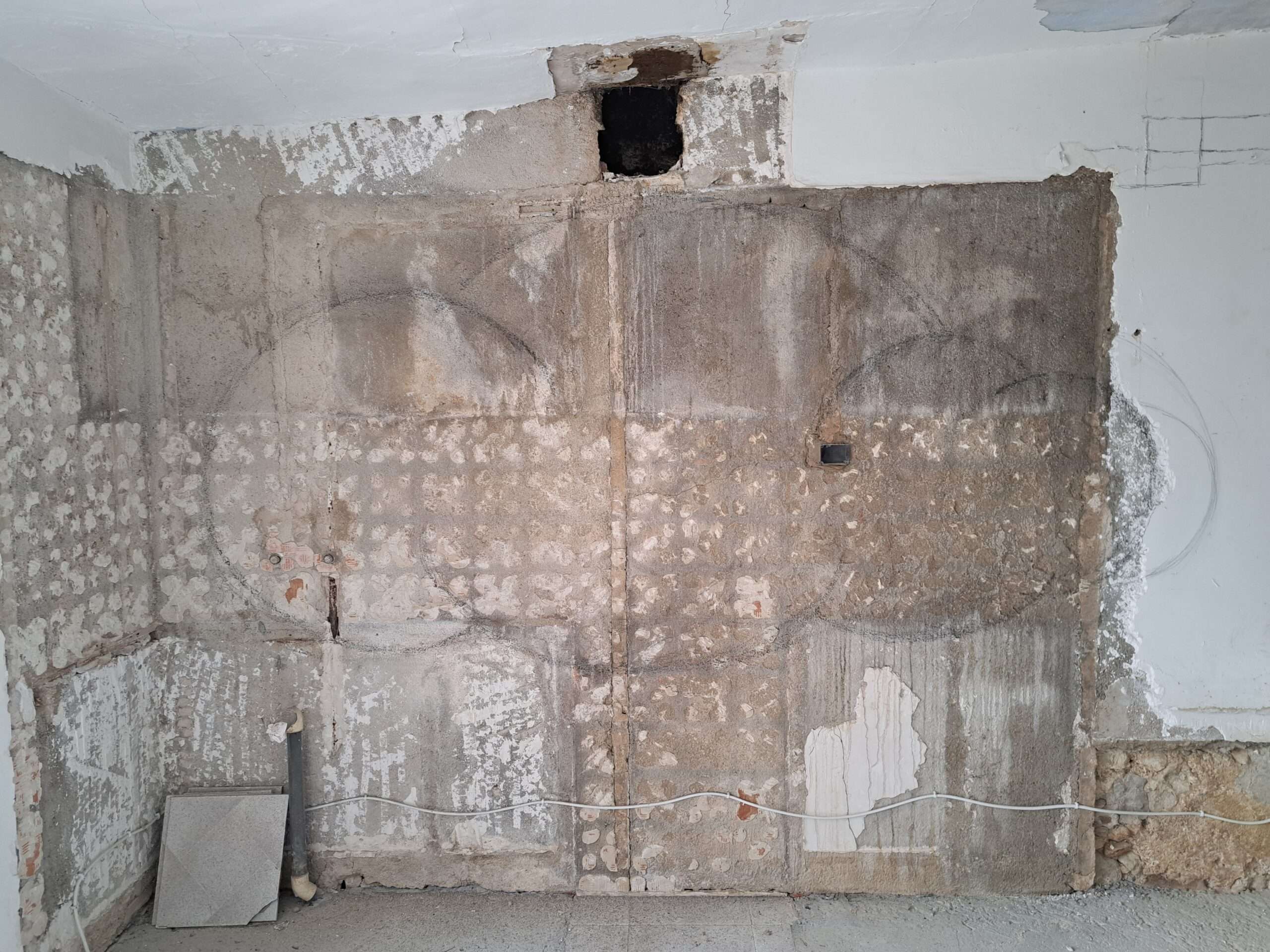 Cleaned up wall, with the old tiles removed ready to start the mosaic. The cloud shape is drawn on the wall