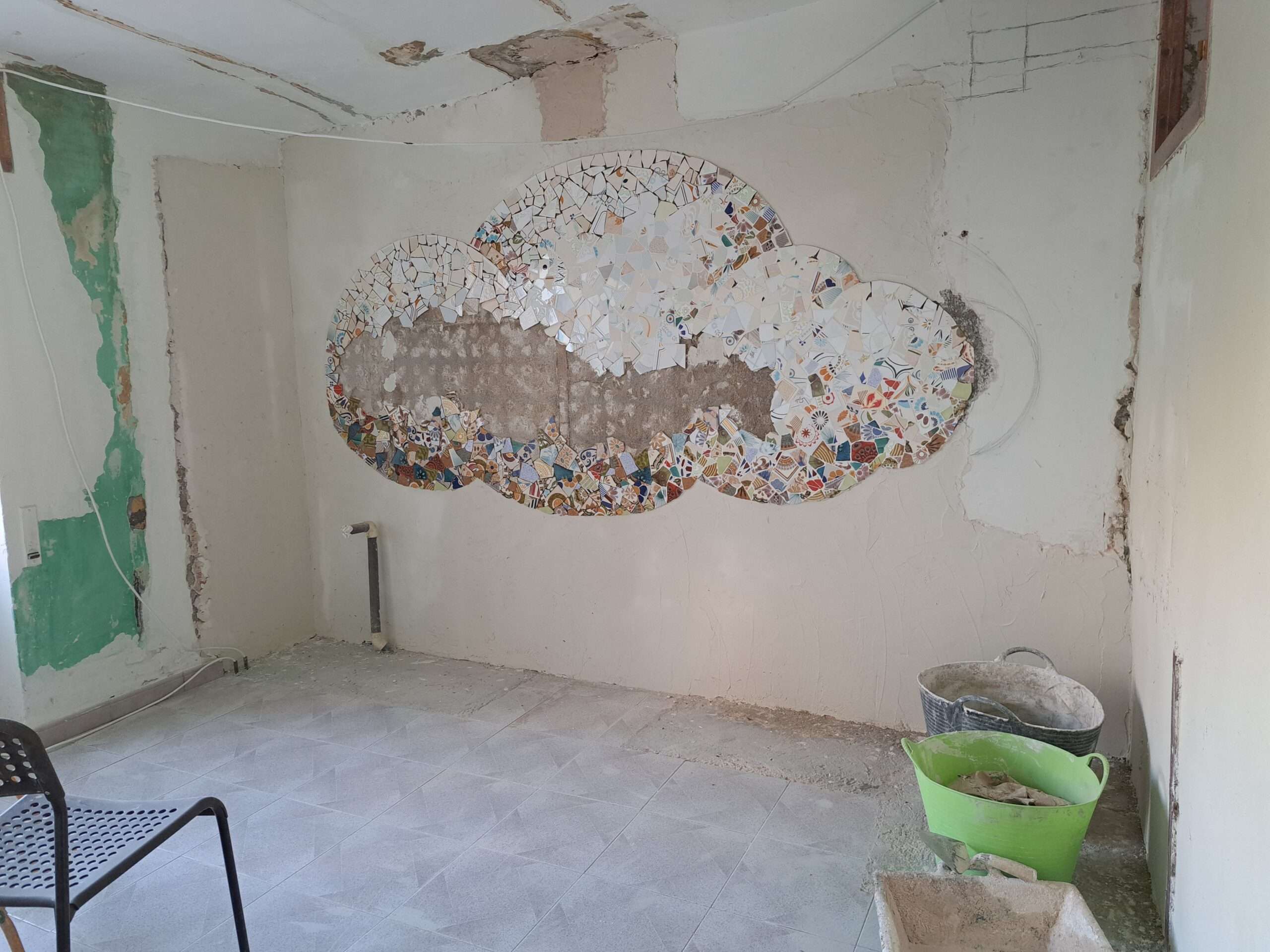 The mosaic is two thirds done, and the surrounding wall is fixed with white plaster